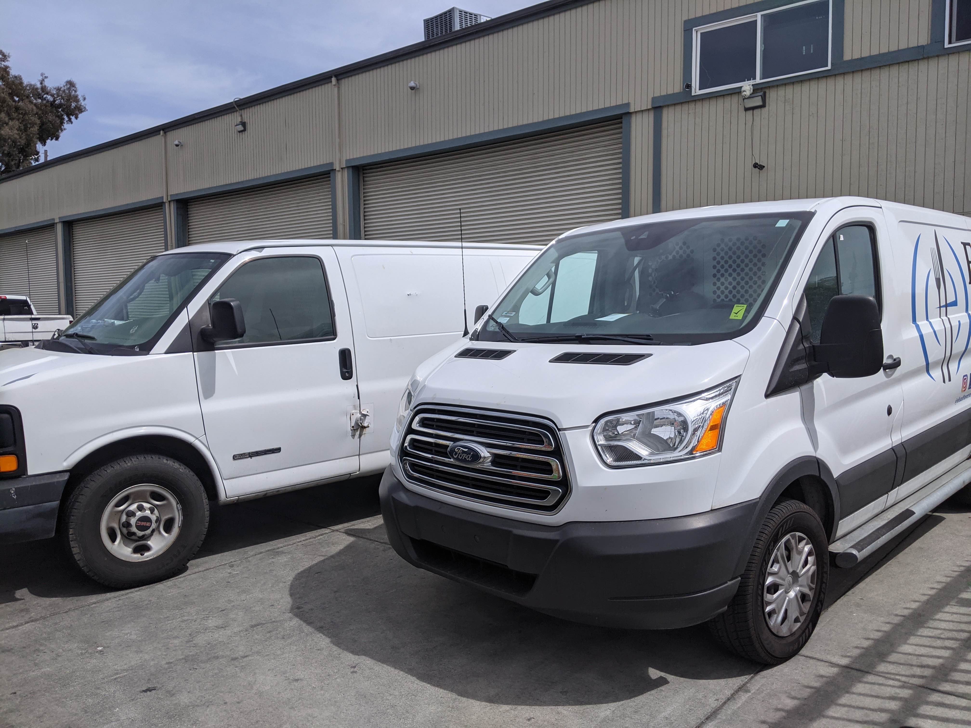 The Pak Food delivery vans parked at the kitchen